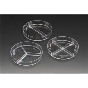 Three clear plastic petri dishes with divided compartments on a black surface.